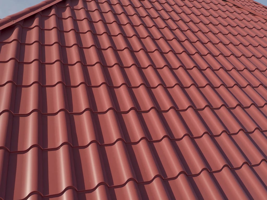 Tile Red Interlock Tile aluminum roof on a red roof on a single-family home in a suburban area, South Barrington, Illinois