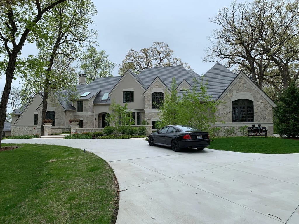 Musket Grey Interlock Slate aluminum roof being installed on the home, replacing an asphalt shingle roof being torn off, Long Grove, Illinois