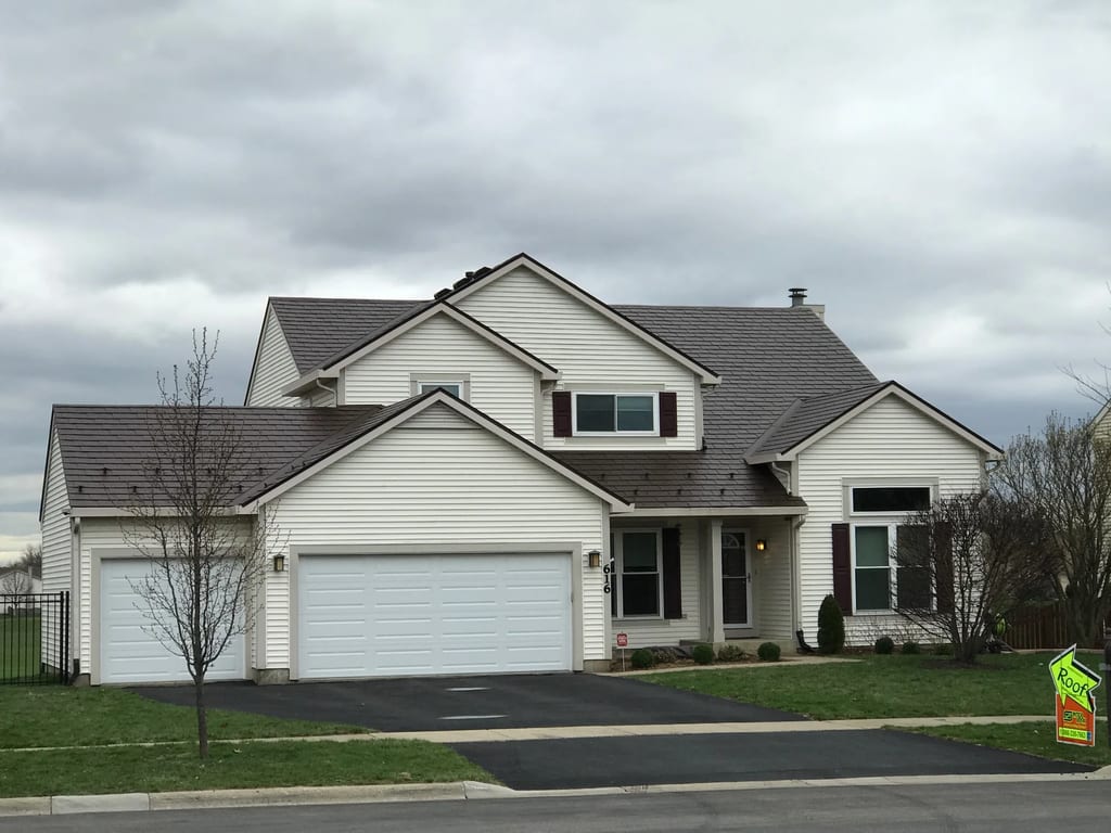 Colonial Brown Interlock Slate aluminum roof on a white two-storey home with dormers in a suburban, Carol Stream, Illinois