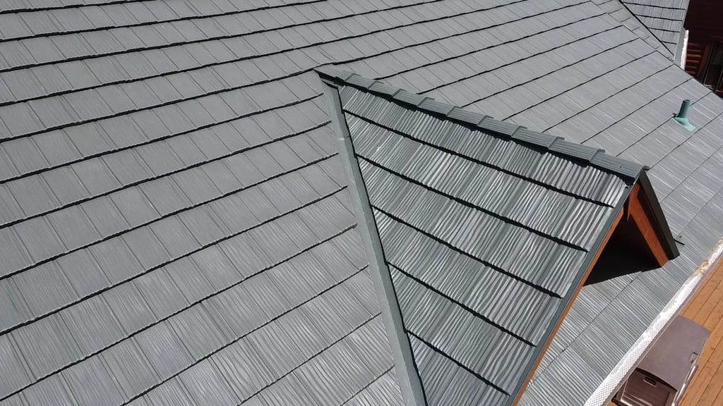 Hunter Green Interlock Shake aluminum roof on a brown two-storey home with dormers on a rural acreage, Harvard, Illinois