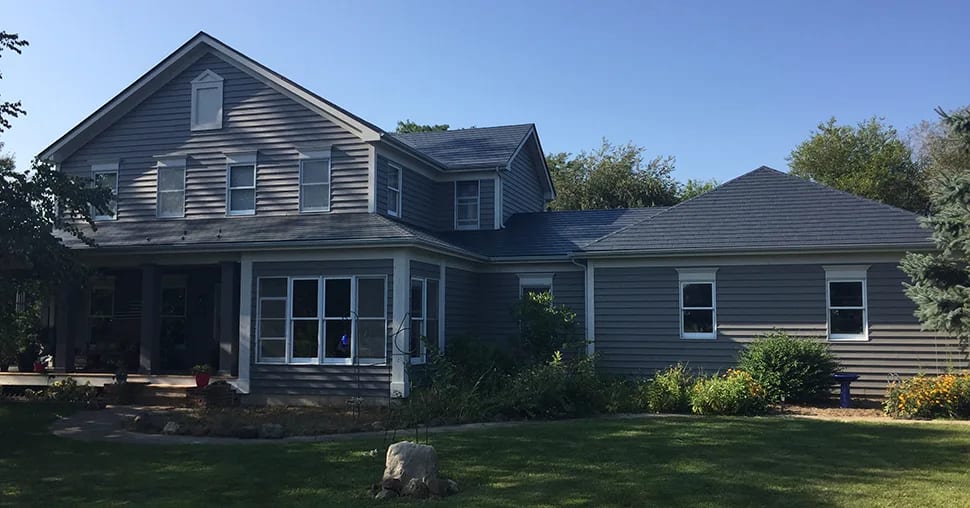 Deep Charcoal Interlock Slate aluminum roof on a deep charcoal two-storey Colonial home with dormers among, Plano, Illinois