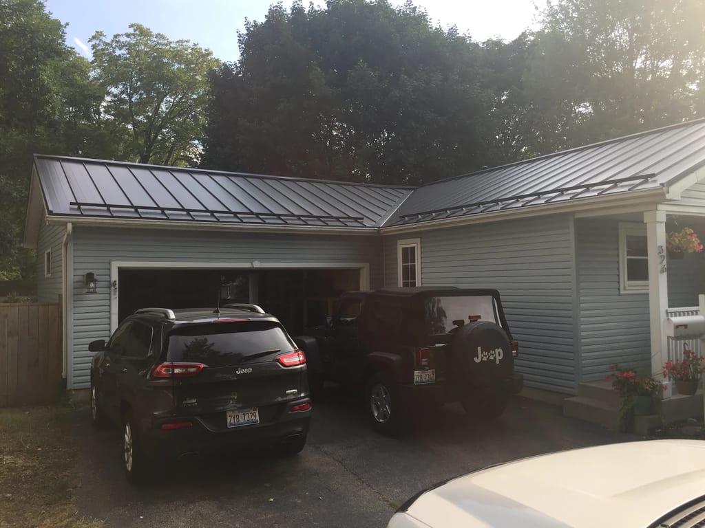 Black Interlock Standing Seam aluminum roof on a two-storey home with a metal roof in a rural setting, Woodstock, Illinois