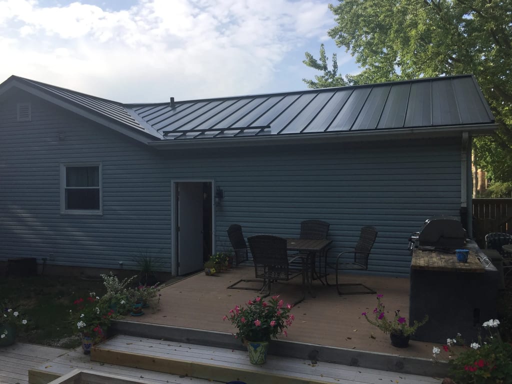 Black Interlock Standing Seam aluminum roof on a two-storey home with metal roof under construction in a, Woodstock, Illinois