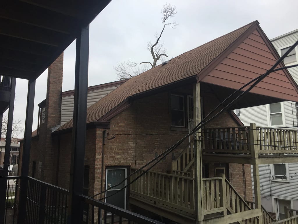 Before: a leaking asphalt shingle roof on the home, Chicago, Illinois, ahead of a Colonial Brown Interlock Slate aluminum roof