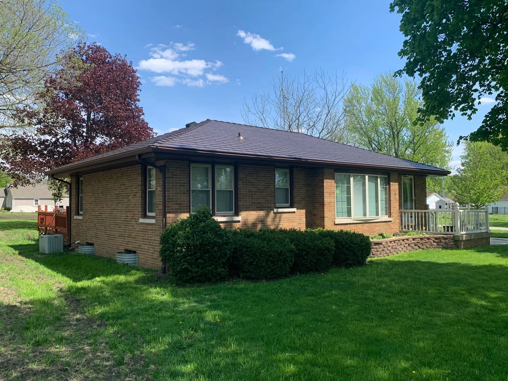 Colonial Brown Interlock Cedar Shingle aluminum roof being installed on a colonial home with a metal roof under construction in a, Wenona, Illinois