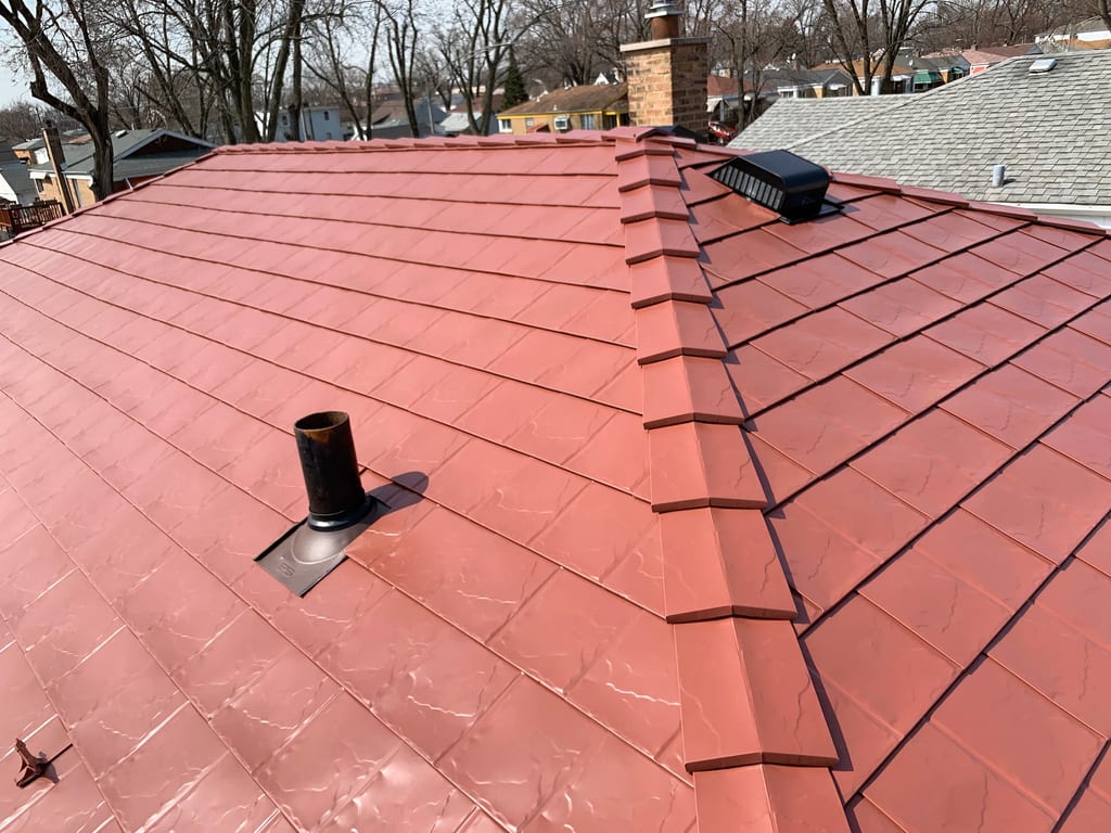 Tile Red Interlock Slate aluminum roof on a red metal roof on a two-storey home in an urban area, Calumet Park, Illinois