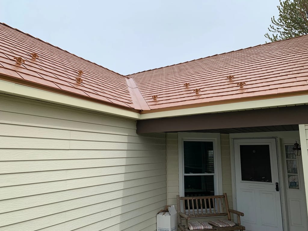 Copper Penny Interlock Cedar Shingle aluminum roof on a white single-family home with a metal roof in a suburban, Bolingbrook, Illinois