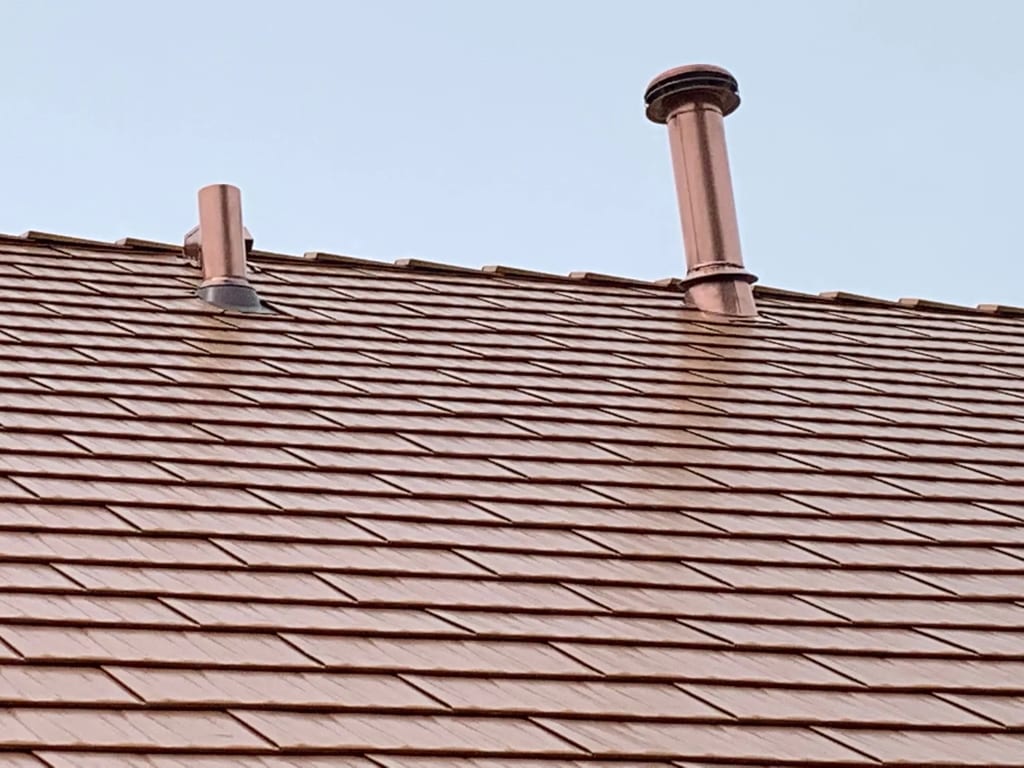Copper Penny Interlock Cedar Shingle aluminum roof on a brown single-family home with a copper penny roof in a, Bolingbrook, Illinois