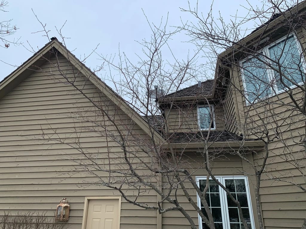 Before: a worn out wood shake roof on the home, Crystal Lake, Illinois, ahead of a Deep Charcoal Interlock Slate aluminum roof