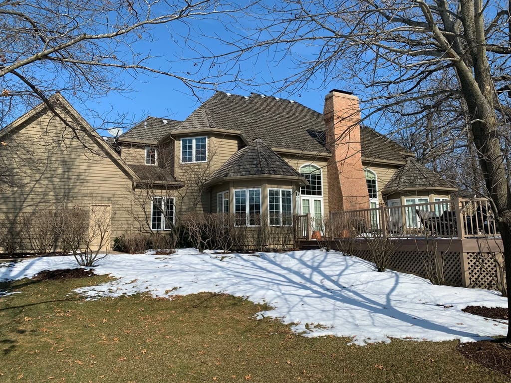 Before: a worn out wood shake roof on the home, Crystal Lake, Illinois, ahead of a Deep Charcoal Interlock Slate aluminum roof