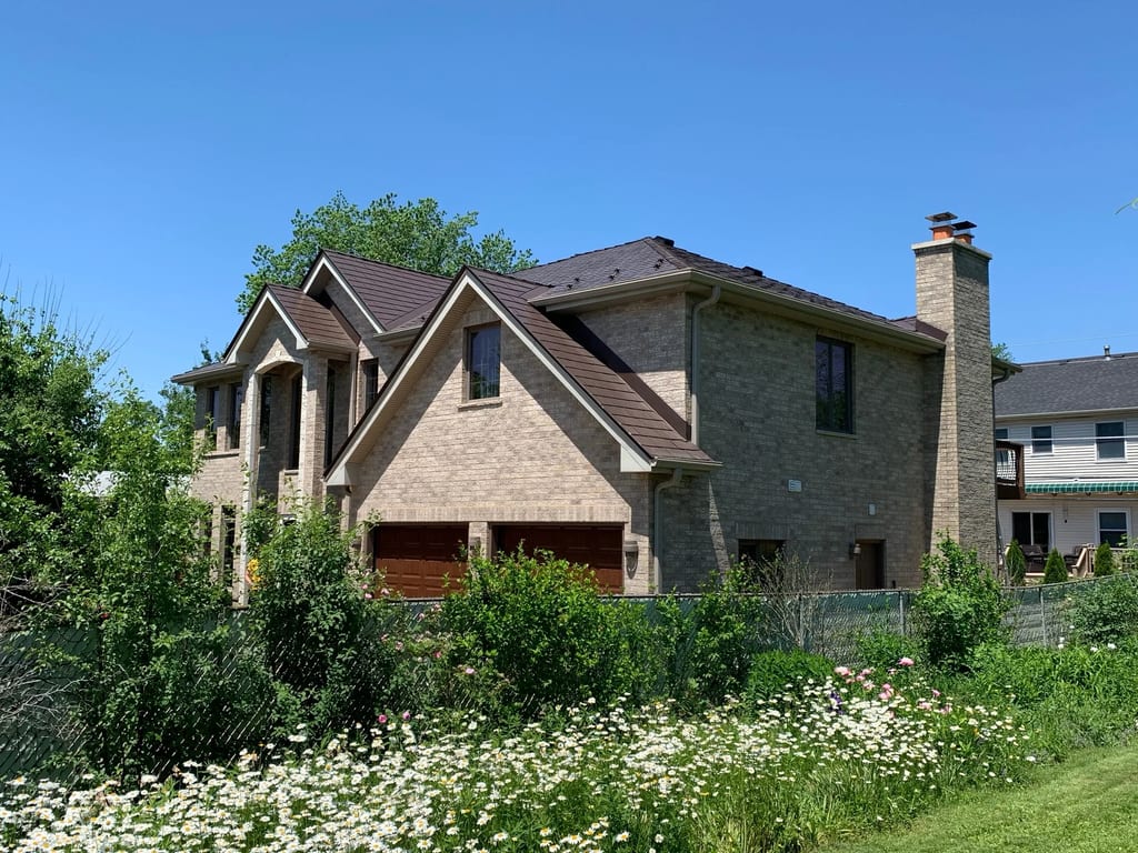 Colonial Brown Interlock Slate aluminum roof on a brown two-storey Colonial home with a brown metal roof in, Calredon Hills, Illinois