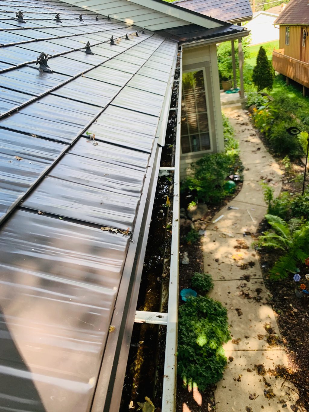 Tudor Brown Interlock Cedar Shingle aluminum roof on a home with a metal roof in a wooded setting, Algonquin, Illinois