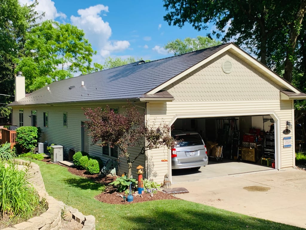 Tudor Brown Interlock Cedar Shingle aluminum roof on a cream-coloured ranch home with a grey roof among tall, Algonquin, Illinois