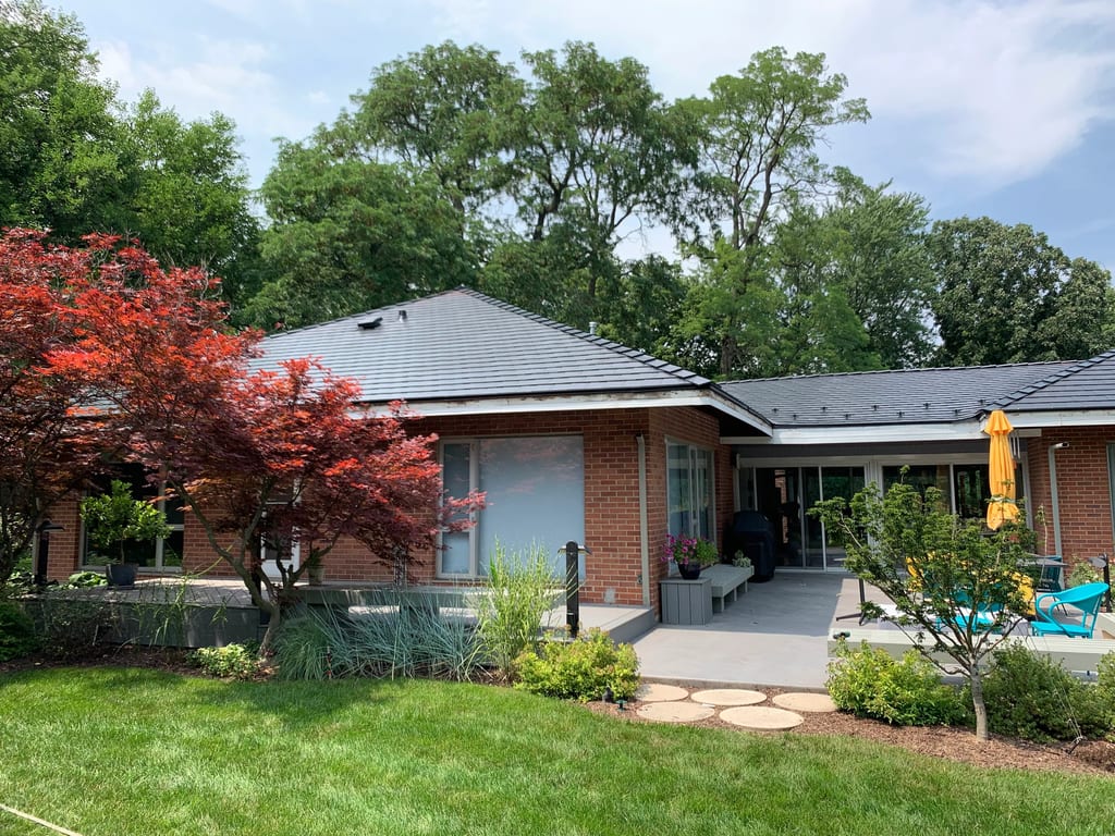 Black Interlock Slate aluminum roof on a red brick home with a metal roof in a suburban setting, Flossmoor, Illinois