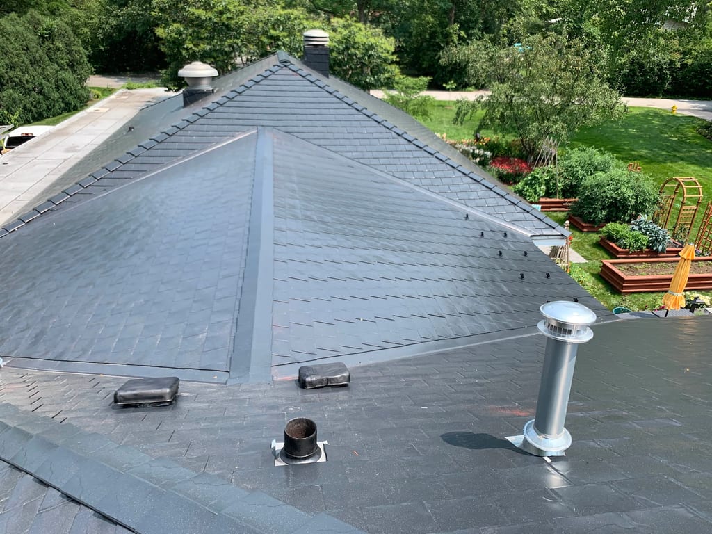 Black Interlock Slate aluminum roof on a two-storey home with a black metal roof in a suburban, Flossmoor, Illinois