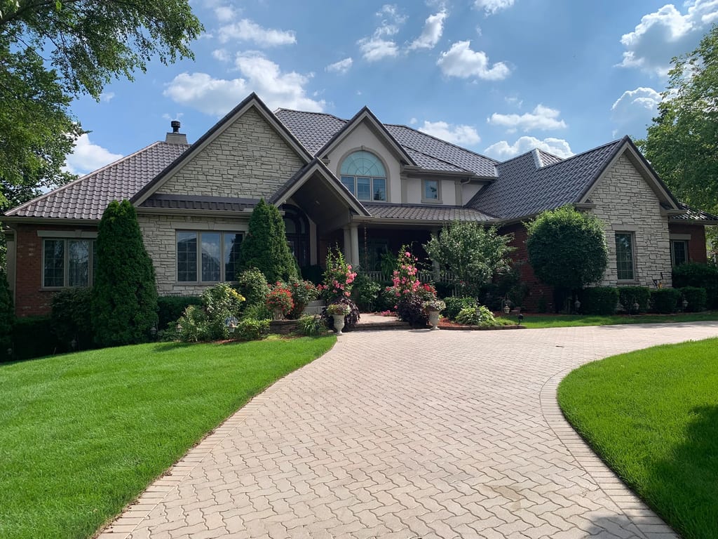 Tudor Brown Interlock Tile aluminum roof on a Tudor Brown metal roof on a colonial style home in a, Lemont, Illinois