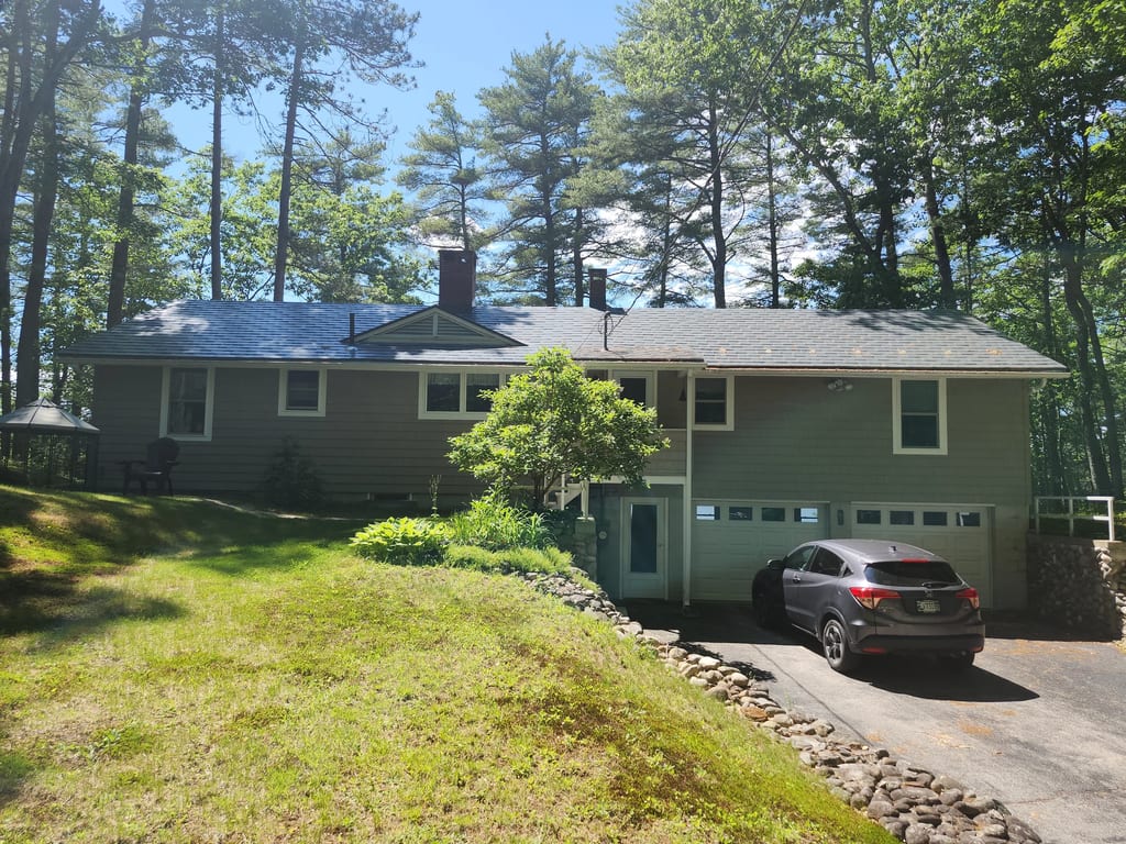 Charcoal Grey Interlock Shingle aluminum roof on a grey ranch style home with a metal roof in a wooded area, New Gloucester, Maine