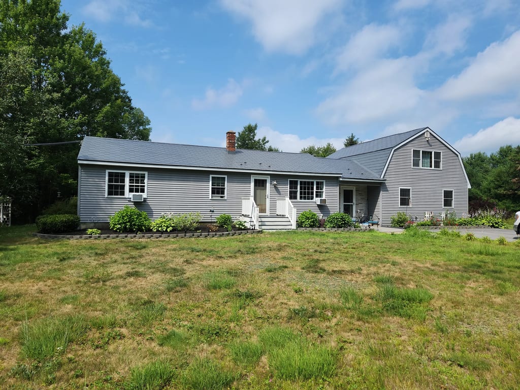 Charcoal Grey Interlock Shingle aluminum roof on a grey ranch home with a metal roof on a rural road, Gray, Maine