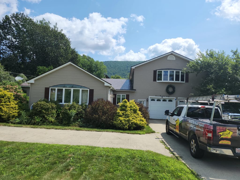 Colonial Brown Interlock Shingle aluminum roof being installed on a colonial home with a brown roof under construction in a, Clarksburg, Massachusetts
