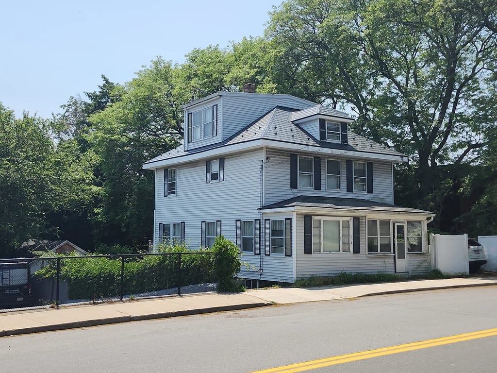 Deep Charcoal Interlock Slate aluminum roof on a Deep Charcoal metal roof on a Colonial home in a forested, Saugus, Massachusetts