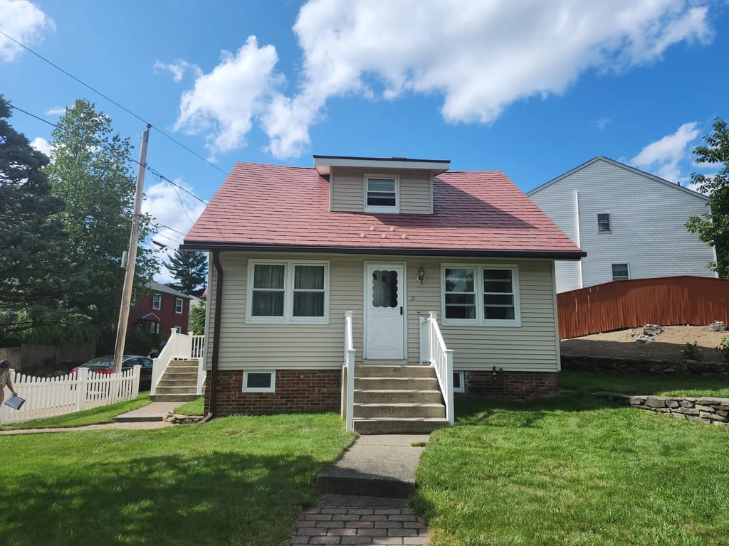 Musket Grey Interlock Slate aluminum roof on a Musket Grey Interlock roof on a Cape Cod home in a lush, Worcester, Massachusetts