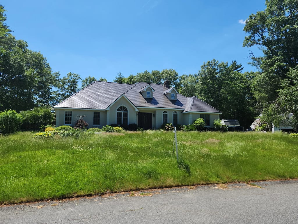 Tudor Brown Interlock Cedar Shingle aluminum roof on a Tudor Brown metal roof on a colonial home in a rural, East Taunton, Massachusetts