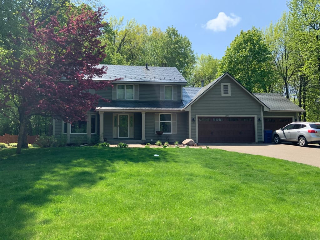 Black Interlock Slate aluminum roof on a gray ranch home with garage in a lush green suburban, Shorewood, Minnesota