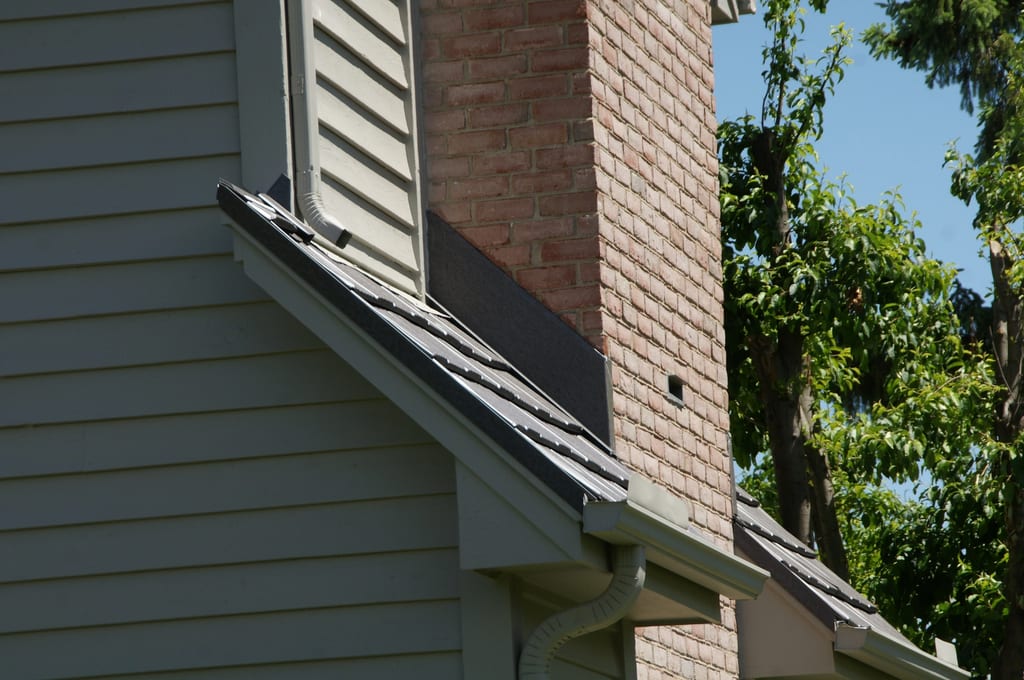 Weathered Interlock Shake aluminum roof on a two-storey home with a brick chimney in a suburban setting, Mendota Heights, Minnesota