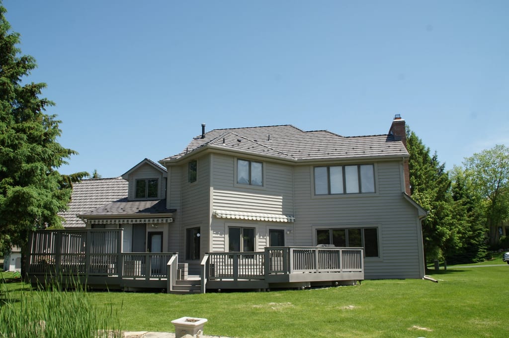 Weathered Interlock Shake aluminum roof on a two-storey home with a metal roof in a wooded suburb, Mendota Heights, Minnesota