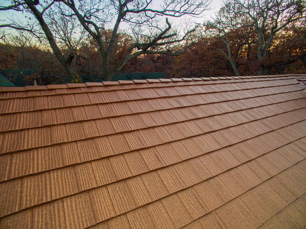 Aged Copper Interlock Shake aluminum roof on a brown single-family modern home with dormers in a, Bloomington, Minnesota