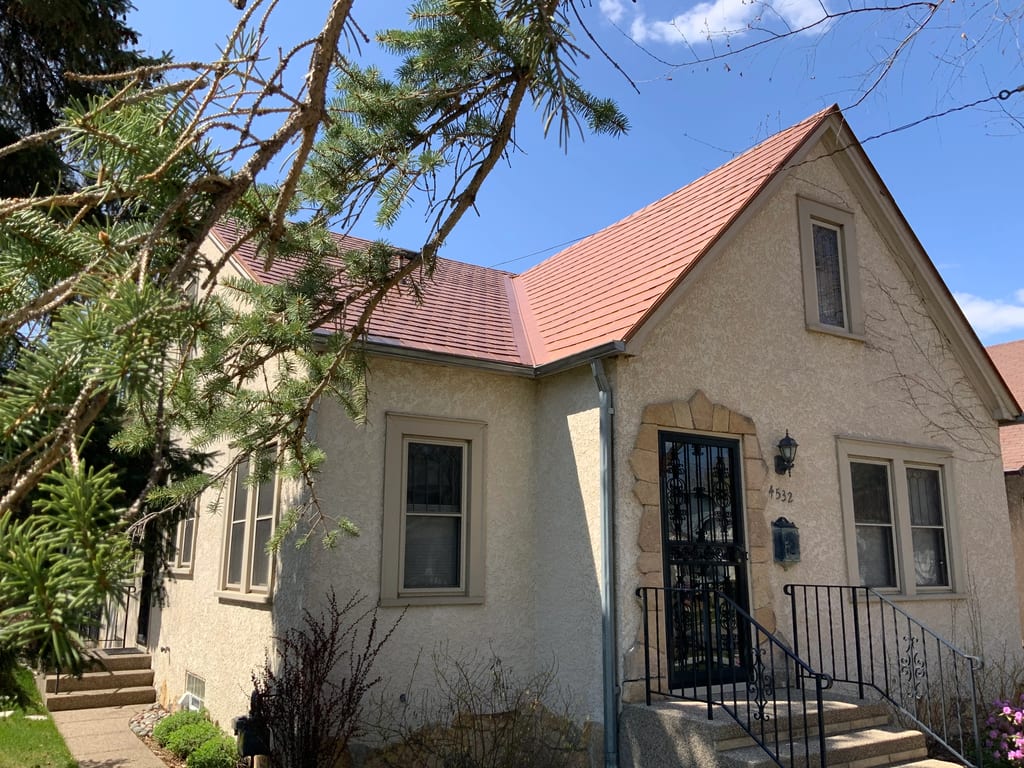 Aged Copper Interlock Slate aluminum roof on a cottage-style home with a red roof and a small front porch, Minneapolis, Minnesota