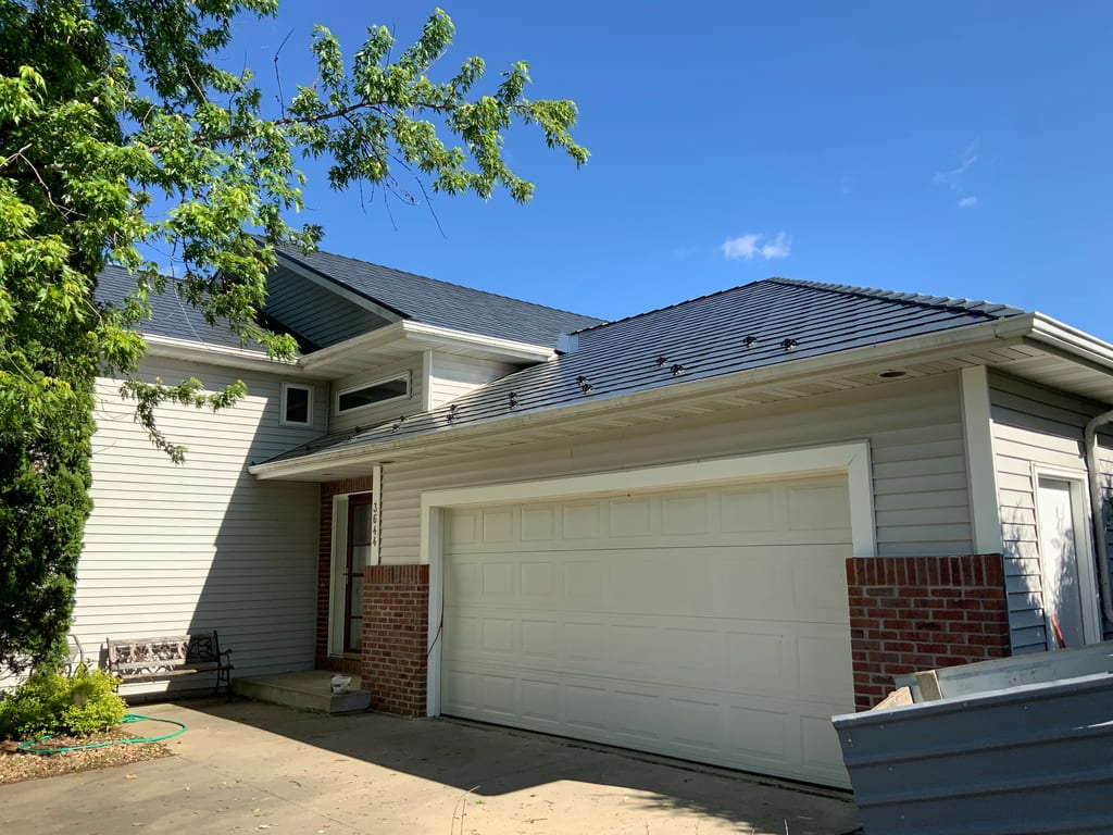 Deep Charcoal Interlock Slate aluminum roof on a ranch-style home with a Deep Charcoal metal roof in a, Rochester, Minnesota