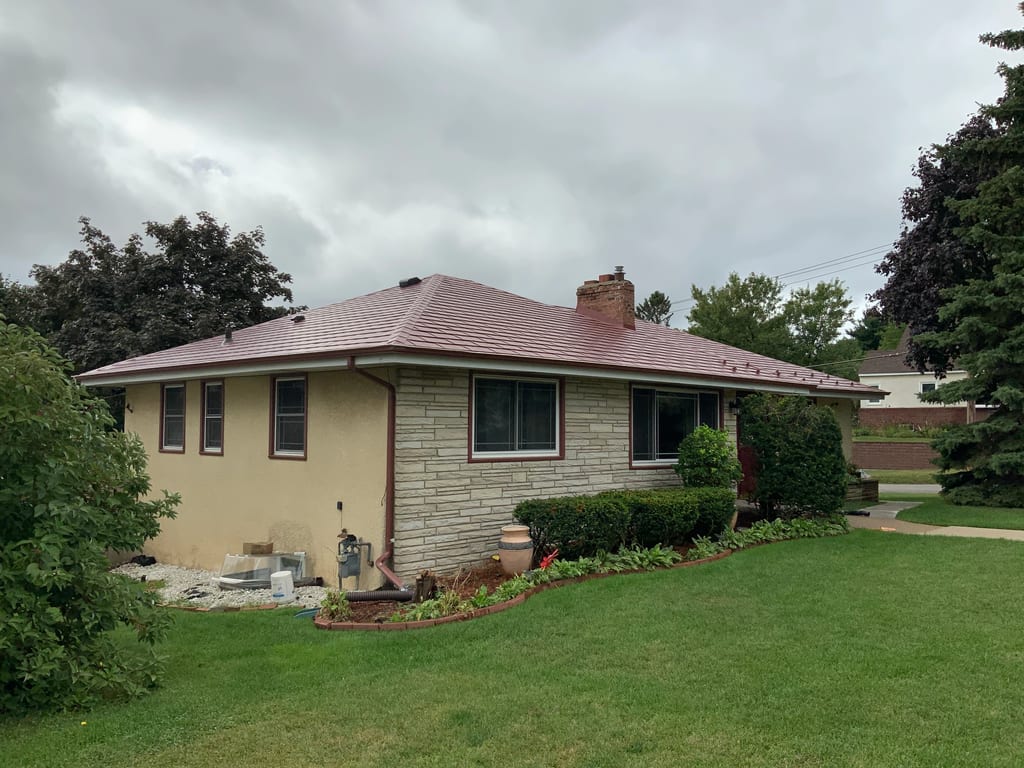 Tile Red Interlock Slate aluminum roof on a two-storey single-family home with a tile red metal roof, St. Paul, Minnesota