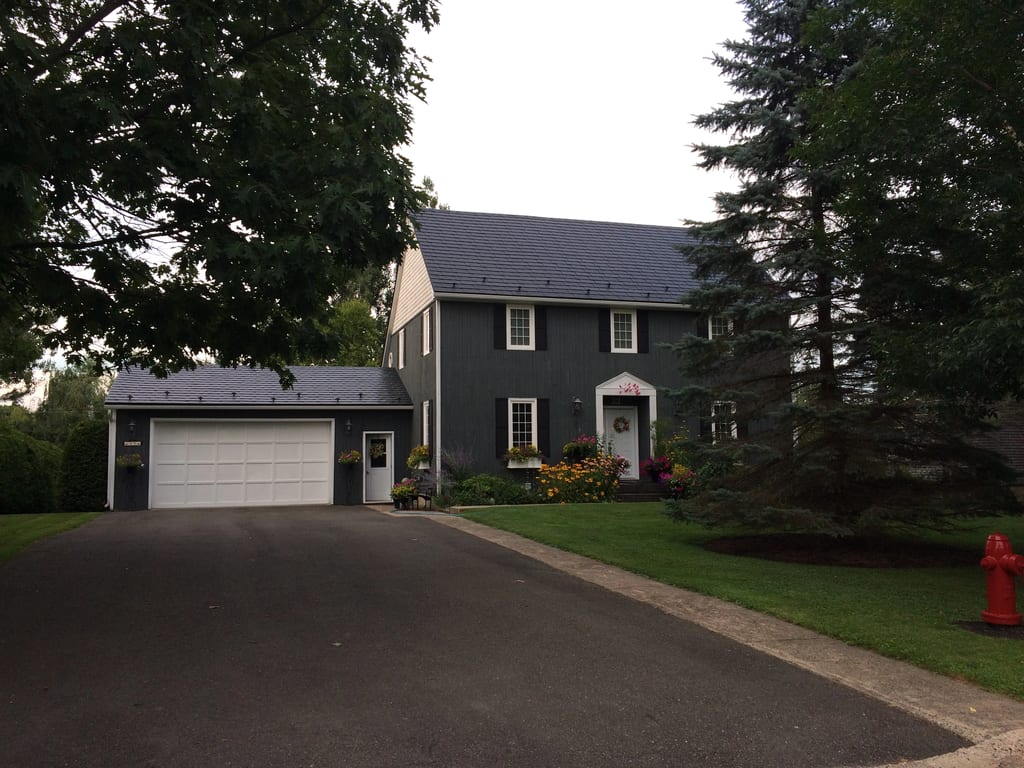 Black Interlock Slate aluminum roof on a black two-storey home with dormers and a metal roof, Fredericton, New Brunswick
