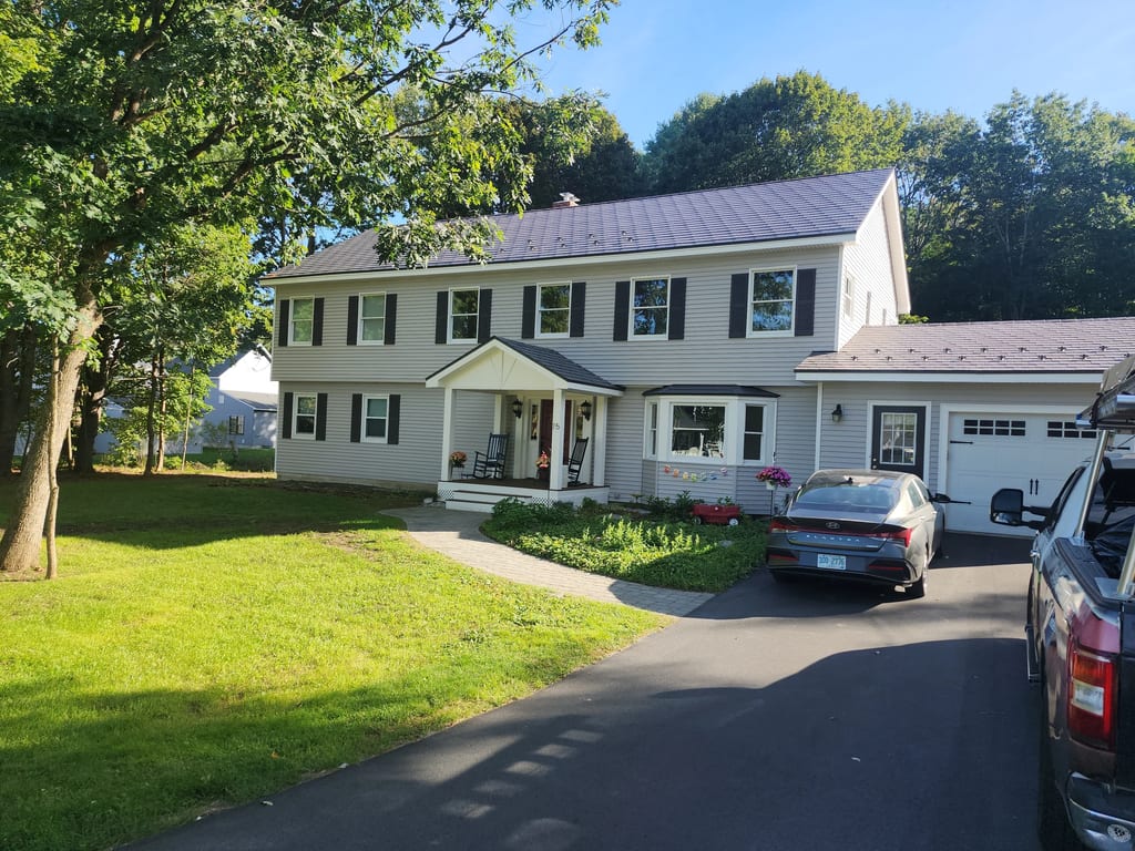 Musket Grey Interlock Slate aluminum roof on a two-storey colonial home with a grey metal roof in a, West Lebanon, New Hampshire