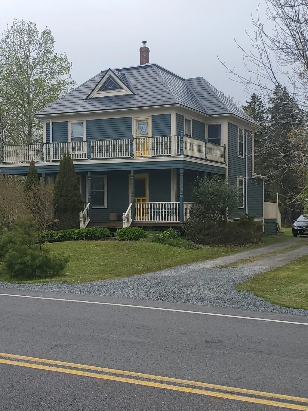 Black Interlock Slate aluminum roof on a two-storey Cape Cod home with dormers in a rural area, Riverport, Nova Scotia