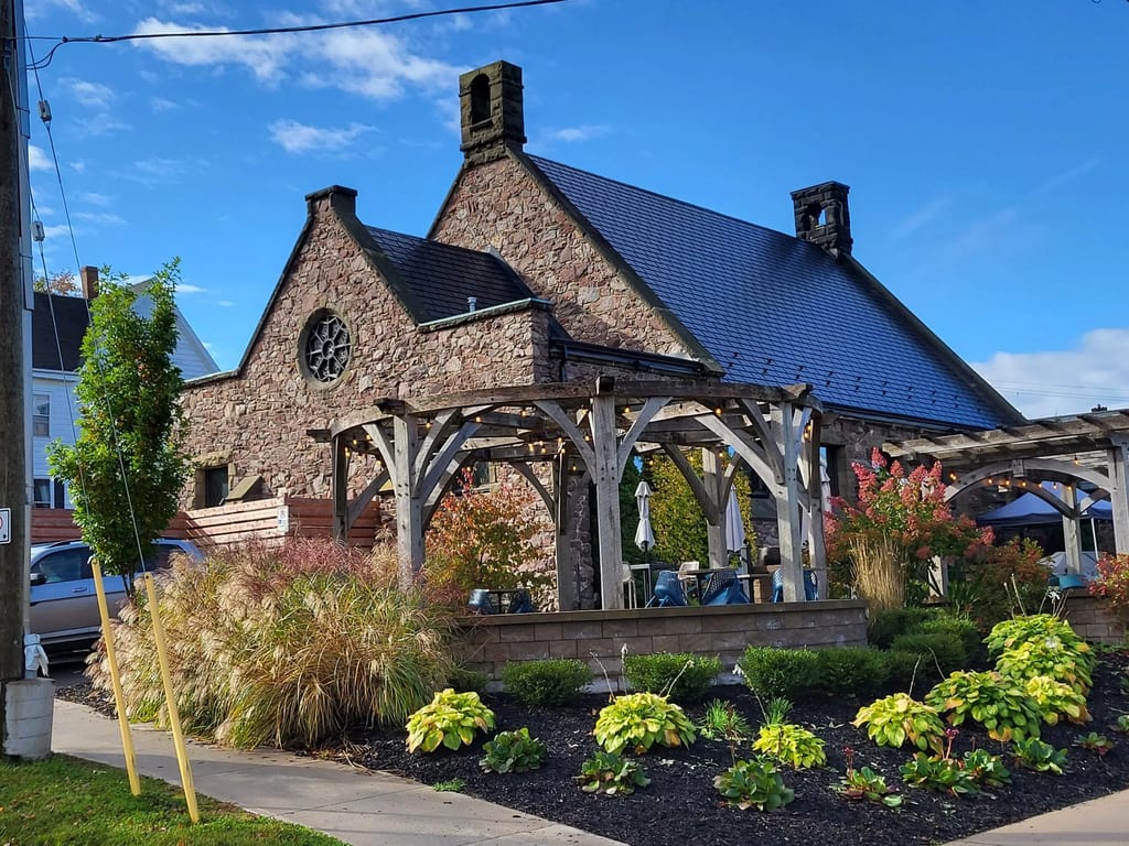 Black Interlock Slate aluminum roof on a heritage-style home with dormers and a slate roof in, Wolfville, Nova Scotia