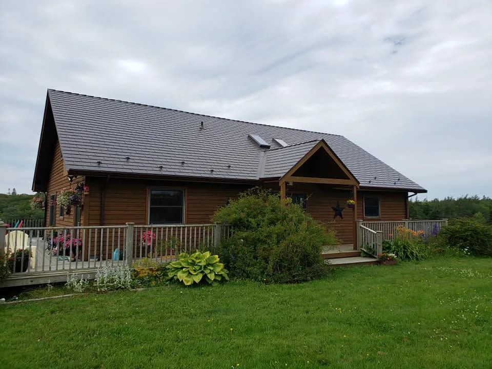 Tudor Brown Interlock Cedar Shingle aluminum roof on the home with roof louver, Darlings Lake, Nova Scotia