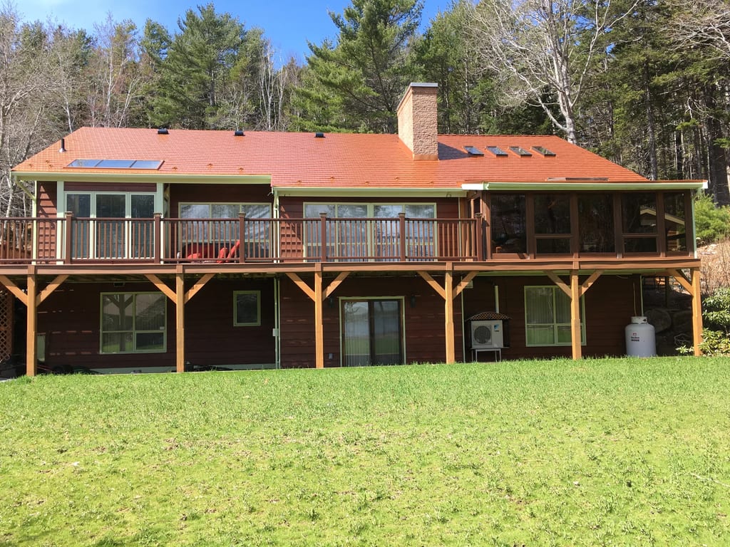 Copper Penny Interlock Cedar Shingle aluminum roof on the home with chimney, Pentz, Nova Scotia