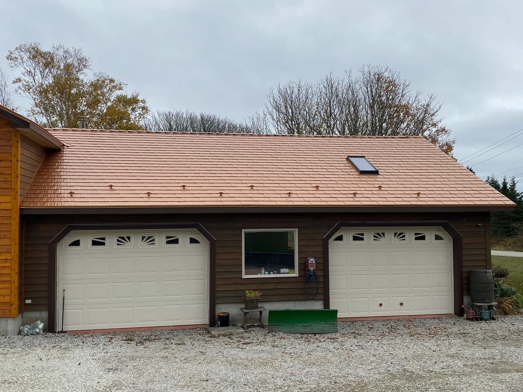 Copper Penny Interlock Cedar Shingle aluminum roof on a brown single-storey cottage with a copper penny metal, Arcadia, Nova Scotia