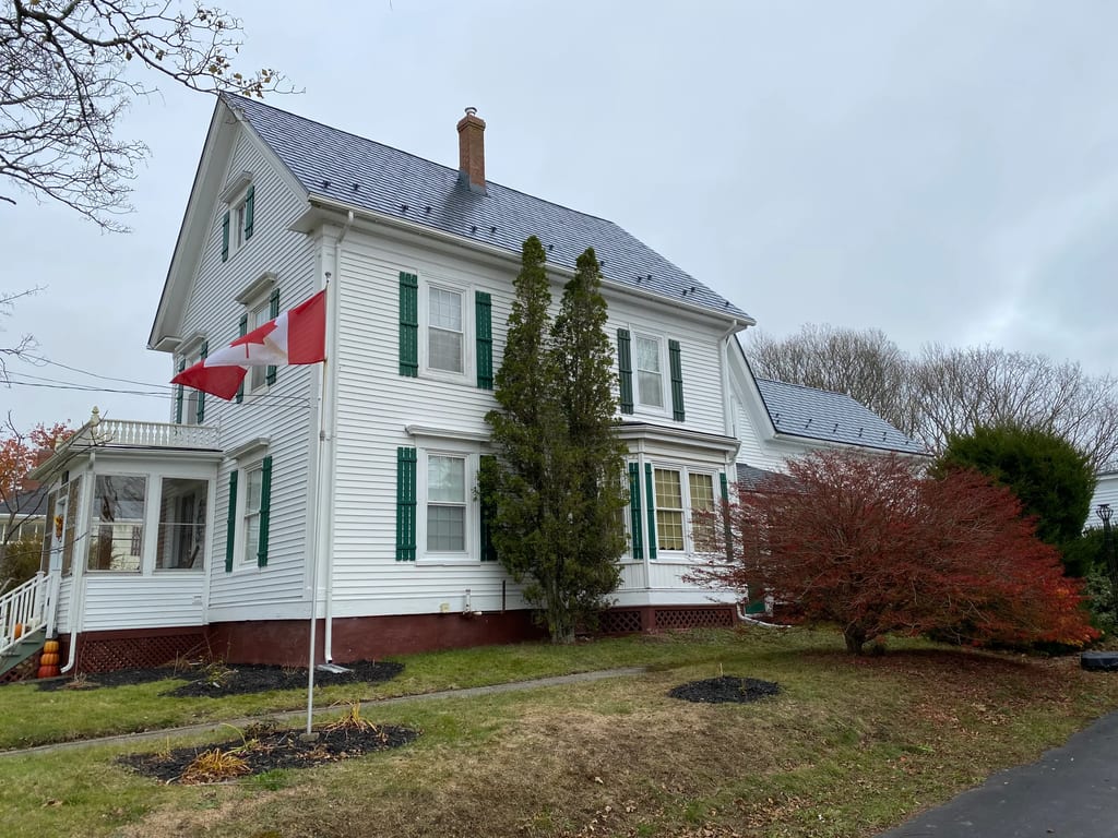 Deep Charcoal Interlock Slate aluminum roof on the home with chimney and dormer, Hebron, Nova Scotia