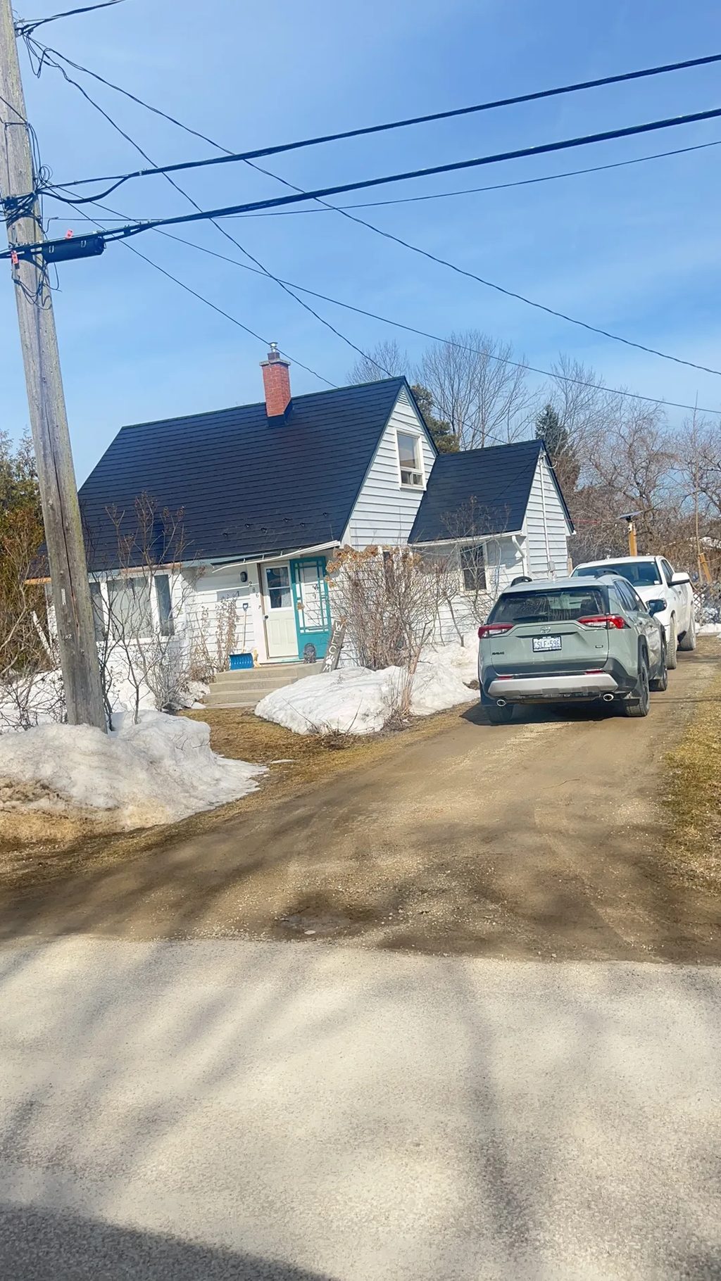 Black Interlock Slate aluminum roof being installed on the home, replacing a worn out asphalt shingle roof, Meaford, Ontario