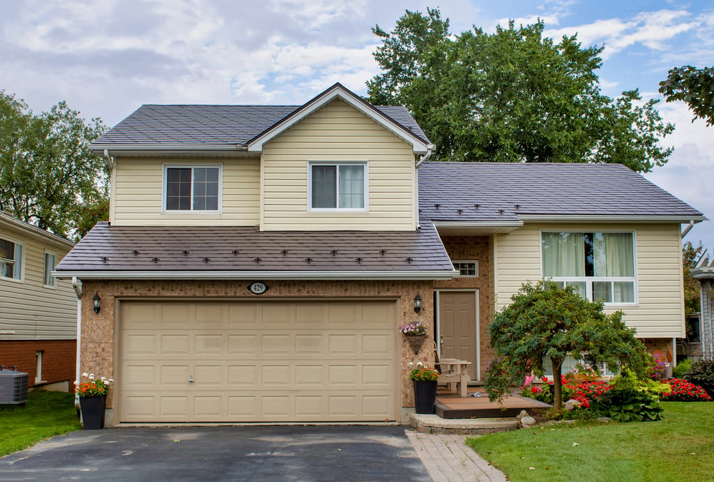 Two-storey suburban home in Shelburne ON with Interlock Tudor Brown aluminum slate metal roofing across multiple roof planes and gable.