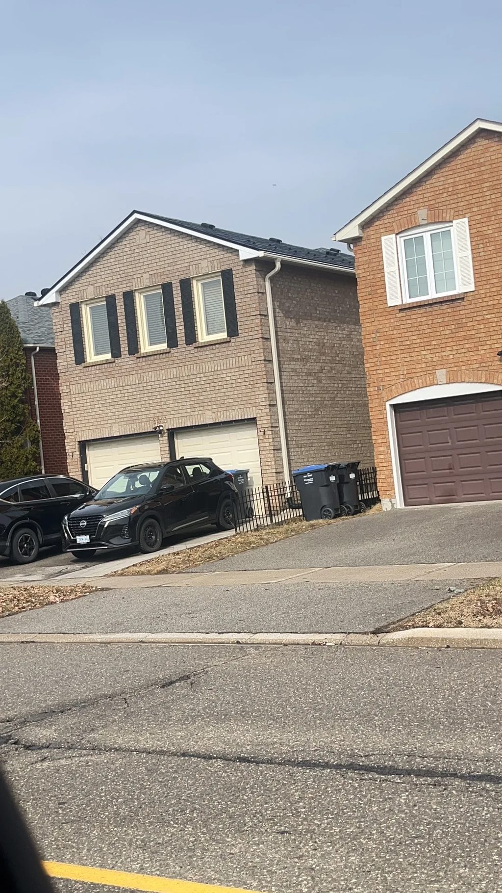 Black Interlock Slate aluminum roof being installed on a brown single-family home with a metal roof in a suburban, Mississauga, Ontario
