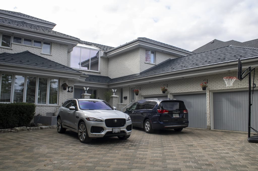 Charcoal Grey Interlock Shake aluminum roof on a white brick house with a garage and a driveway, Whitby, Ontario