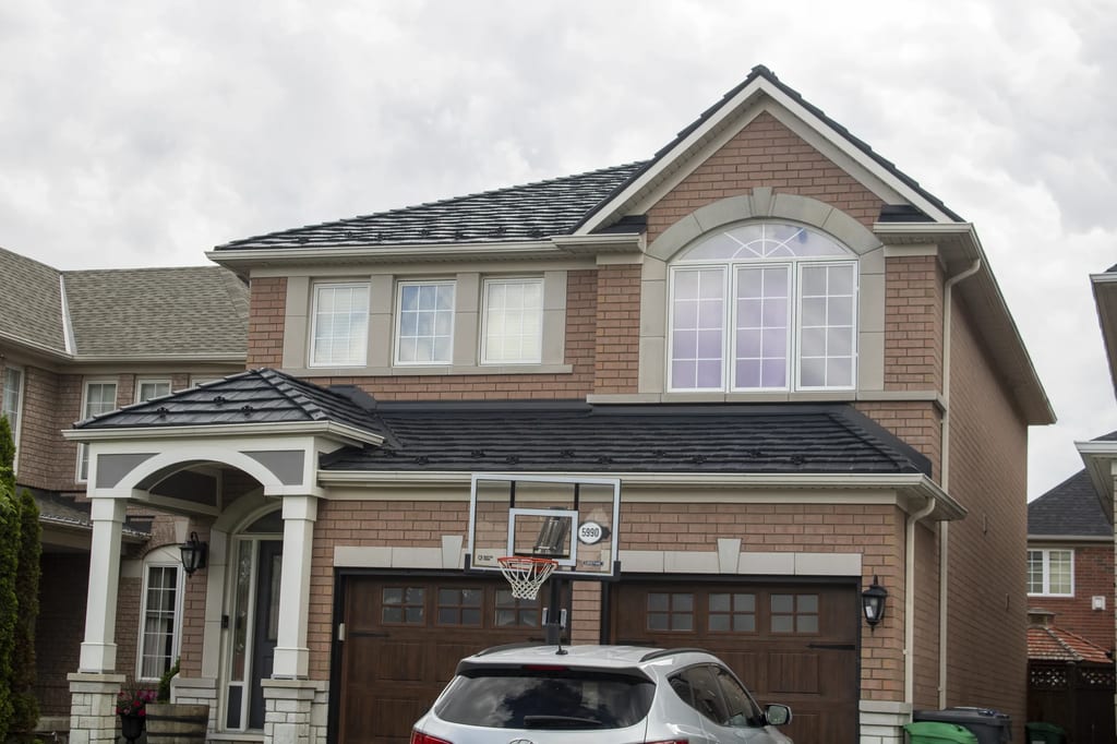Black Interlock Shake aluminum roof on a brick two-storey home with a garage in a residential, Mississauga, Ontario