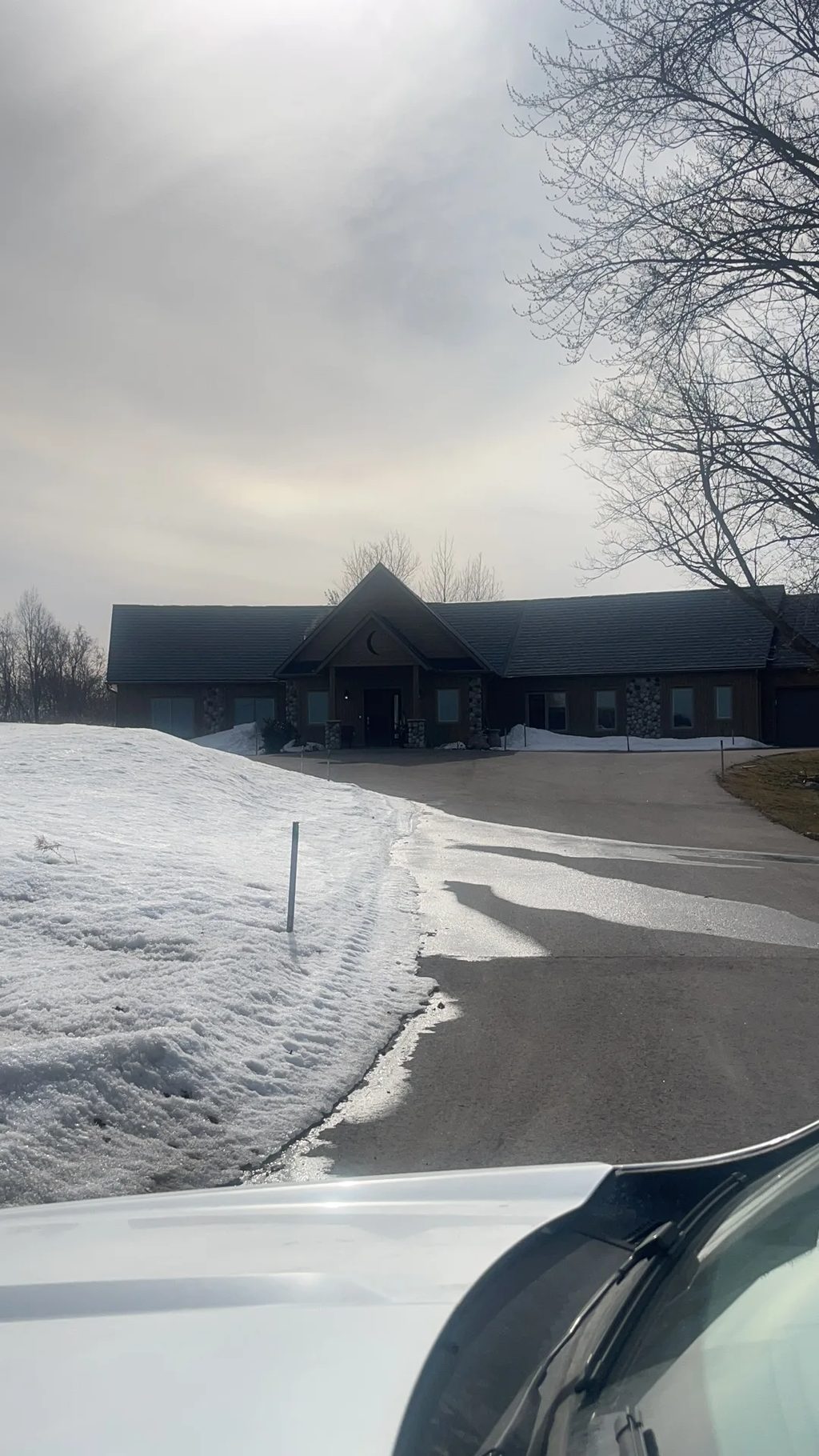 Deep Charcoal Interlock Slate aluminum roof on a ranch home with a metal roof in a snowy rural setting, Springwater, Ontario