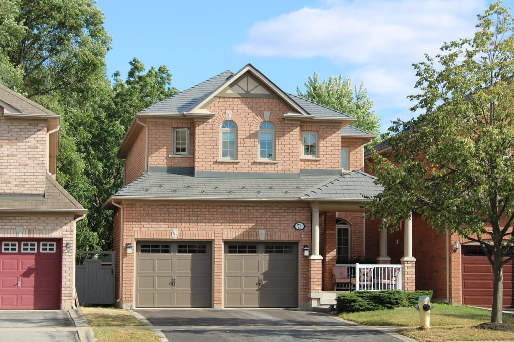 Musket Grey Interlock Cedar Shingle aluminum roof on a two-storey brick home with a Musket Grey metal roof in, Scarborough, Ontario
