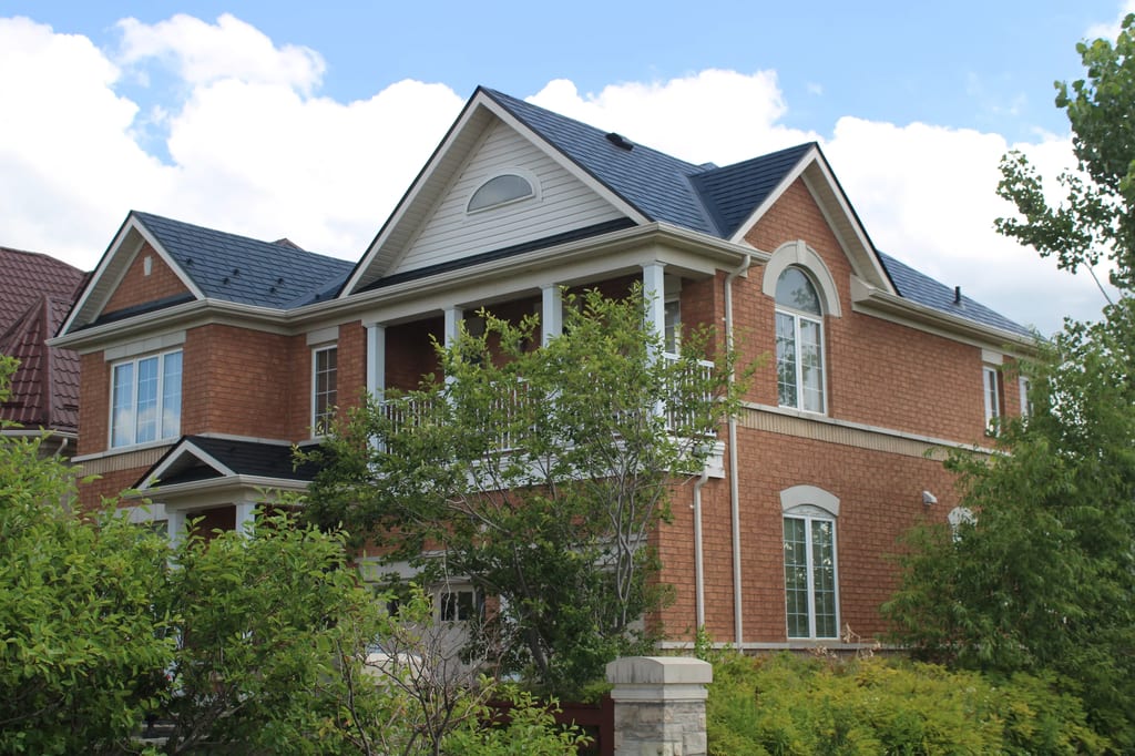 Black Interlock Slate aluminum roof on a red brick home with white trim and a blue Interlock Slate, Markham, Ontario