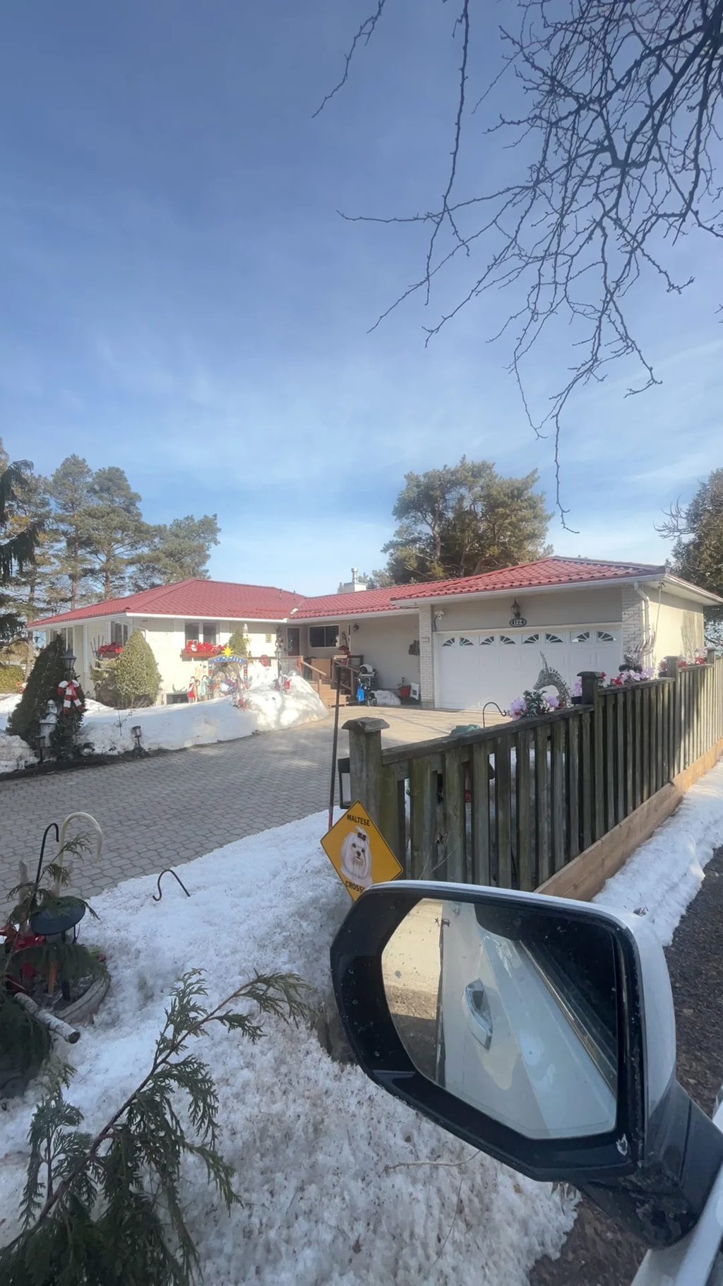 Tile Red Interlock Tile aluminum roof on a red roofed white single-family home with a white garage, Thornbury, Ontario